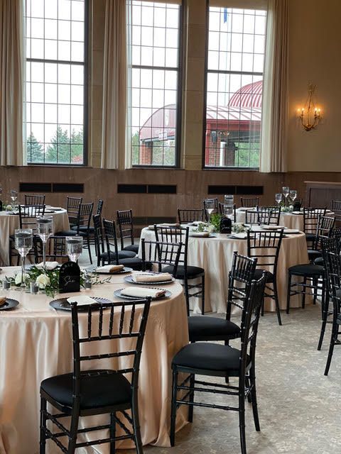 A row of chairs are lined up in a row in a field.