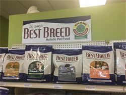 A shelf filled with bags of best breed dog food