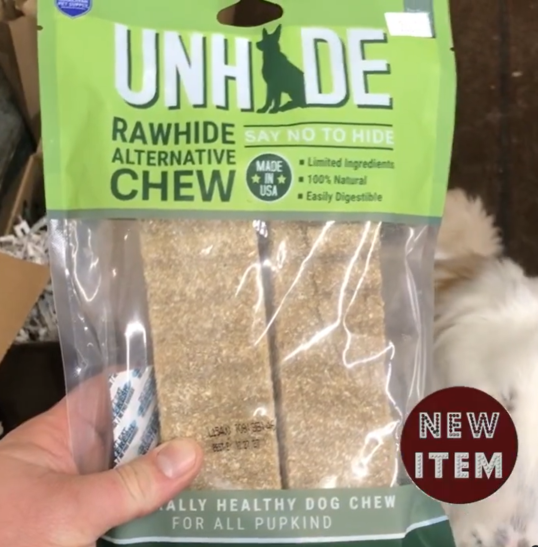 A person is holding a bag of rawhide alternative chew