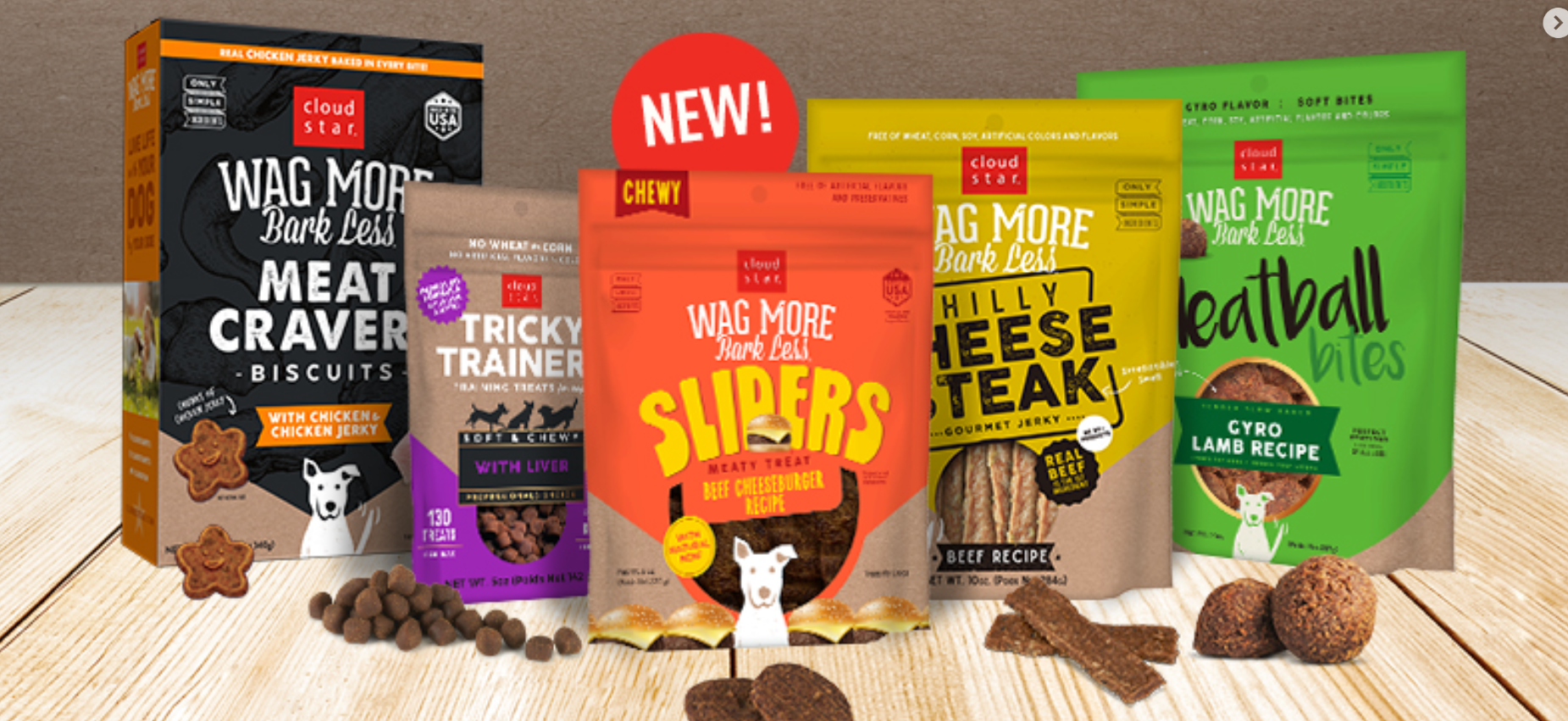 A variety of dog treats are sitting on a wooden table