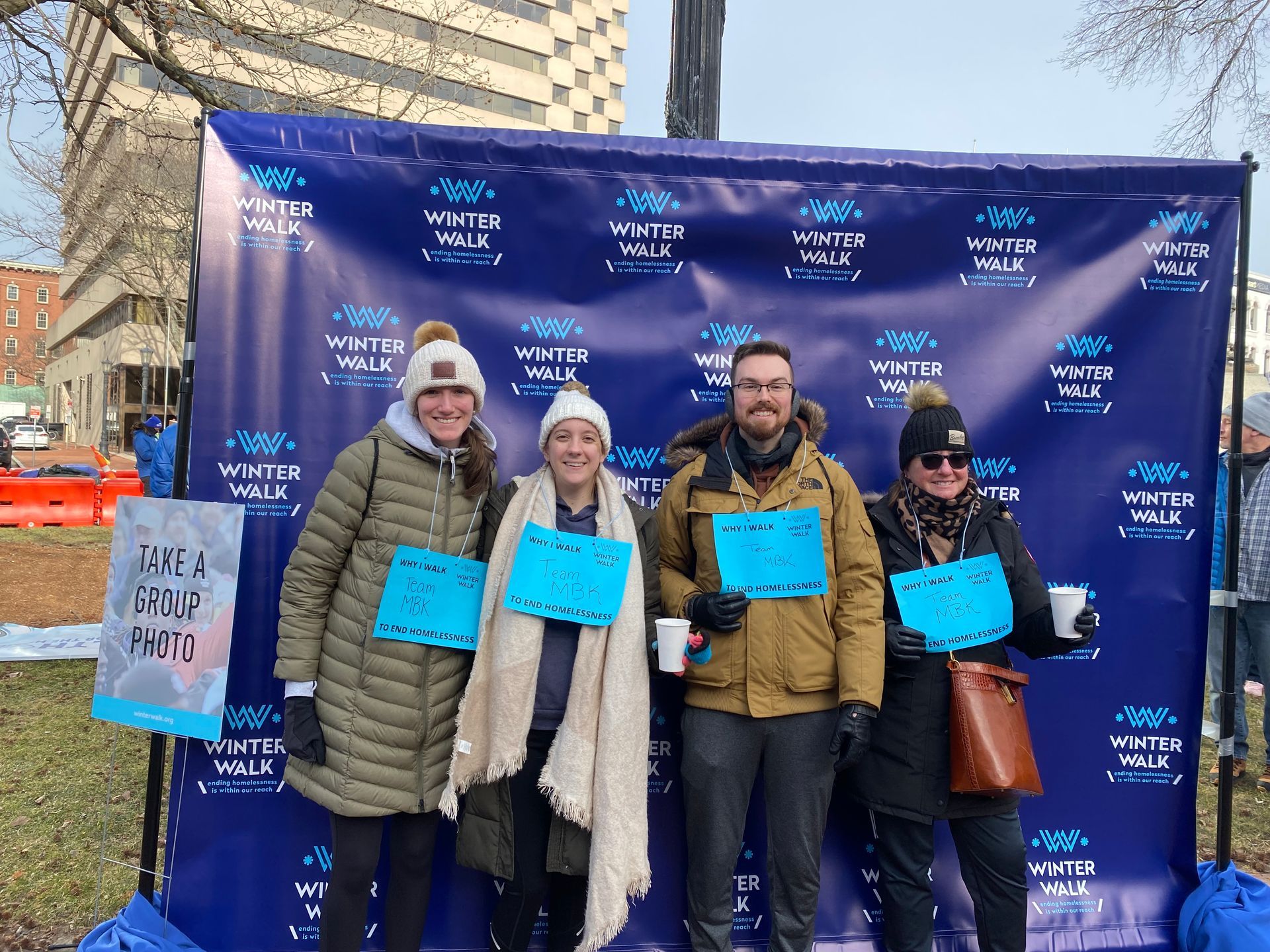 Mia, Keara, Ian and Kris stand together in winter clothes Court Square ready to participate in the inaugural Western MA Winter Walk.