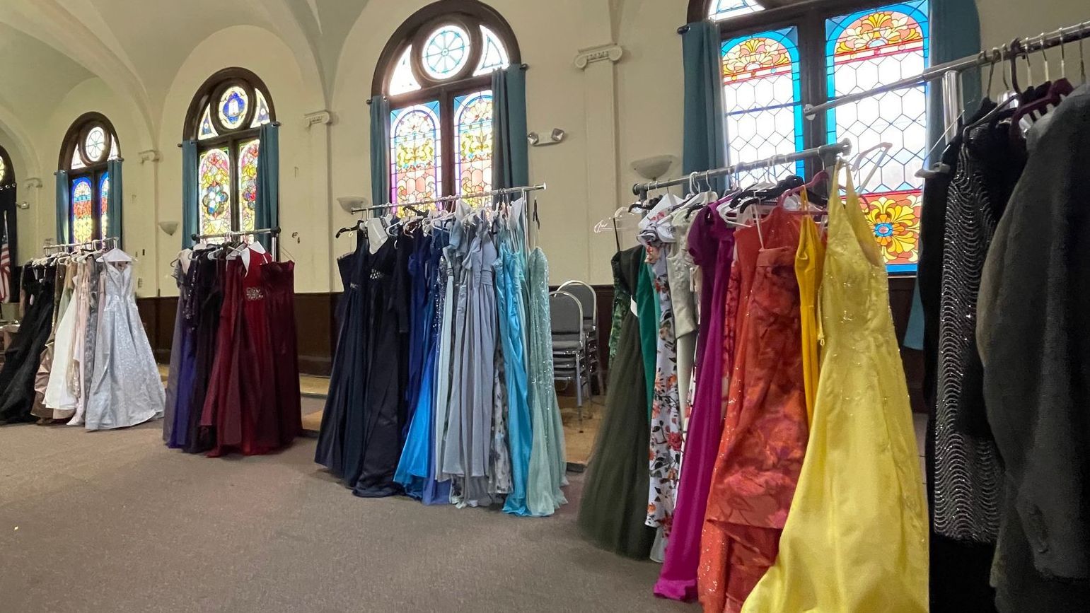 A view of several clothing racks filled with hundreds of gowns ready to be perused by local students.