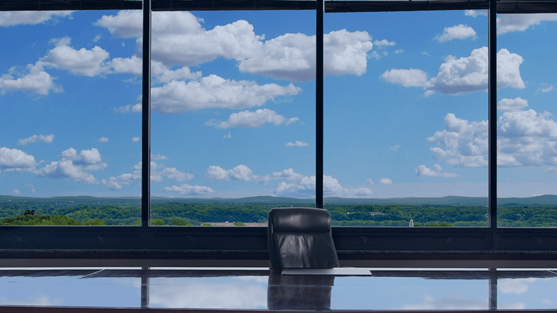 A view out the east-facing windows of MBK's board room looking out at a blue sky and Pioneer Valley