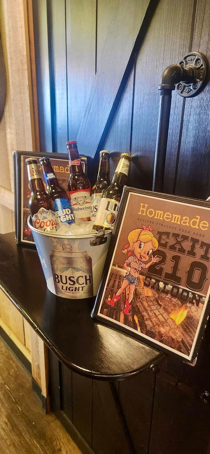 A table with a bucket of beer and a sign on it.