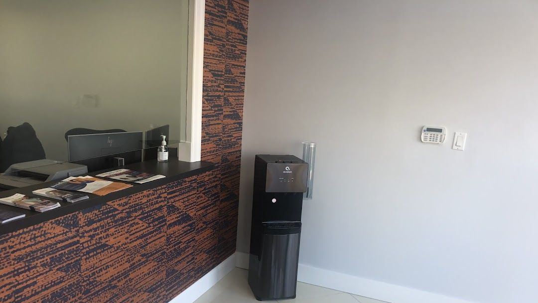 A room with a counter and a computer on the floor.