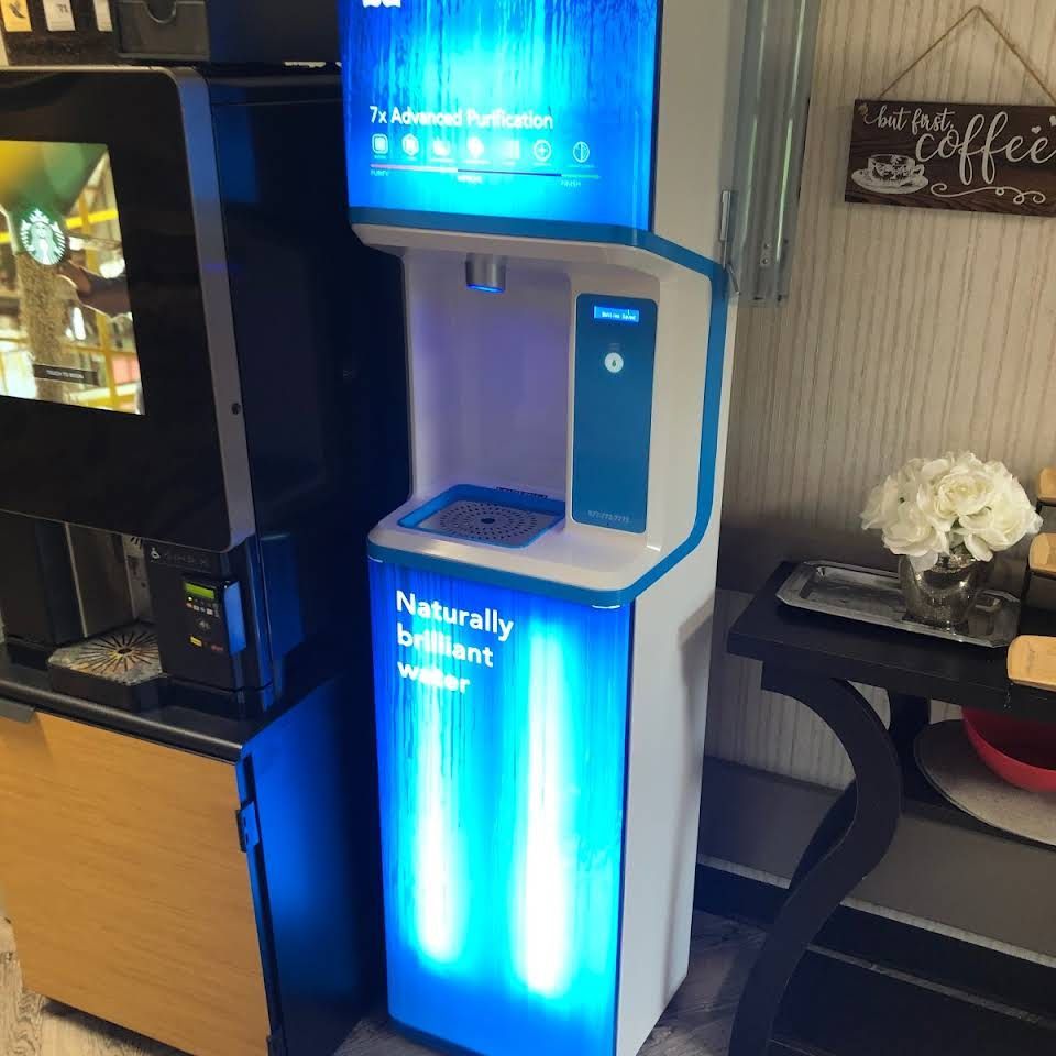 A blue and white water dispenser that says naturally brilliant water