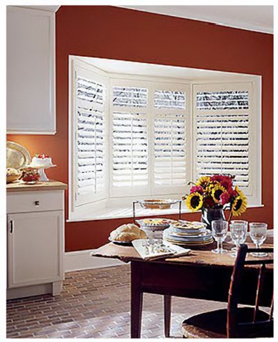 Love is Blinds St. Louis: A dining room with a table and chairs and a window with shutters