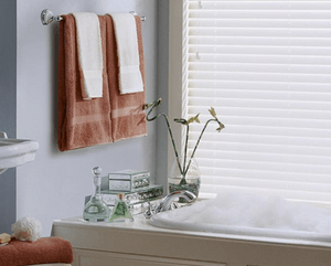 a bathroom with a tub , sink , and window with blinds Love is Blinds Missouri (314) 808-3440.