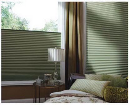 Love is Blinds St. Louis: A bedroom with a bed and a window with green honeycomb shades.