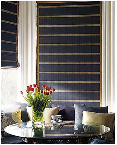 Love is Blinds MO: A living room with a couch, a table, a vase of flowers, and blue roller shades.