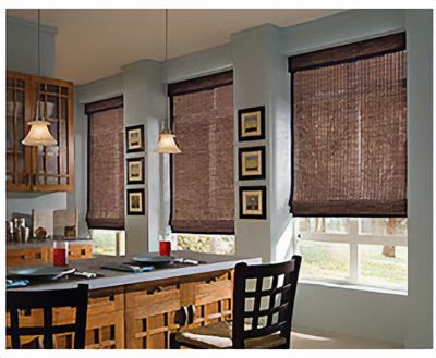 Love is Blinds St. Louis: A kitchen with wooden cabinets , a bar , and a dining table, brown roman shades on windows.