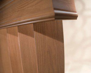 a close up of  wooden veritical blinds with a wooden header Love is Blinds Missouri (314) 808-3440.