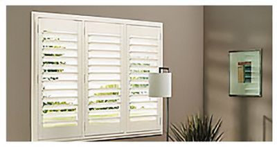 Love is Blinds St. Louis: A living room with a large window with white shutters and a lamp.