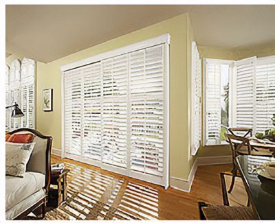 Love is Blinds St. Louis: A living room with sliding glass doors and white shutters