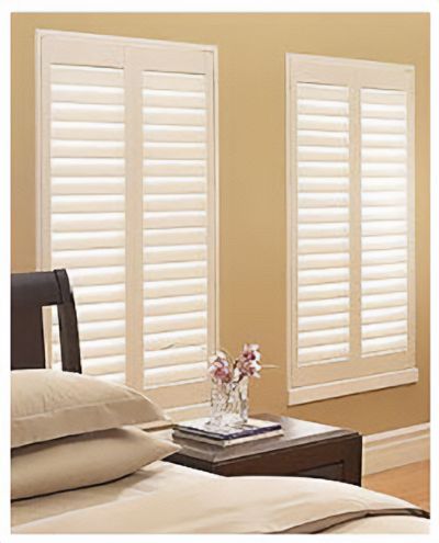 Love is Blinds St. Louis:  A bedroom with a bed , nightstand , and two windows with white shutters.