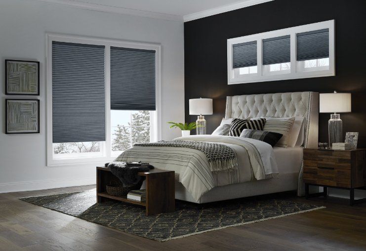 a bedroom with a bed , nightstand , and window shades Love is Blinds Missouri (314) 808-3440.