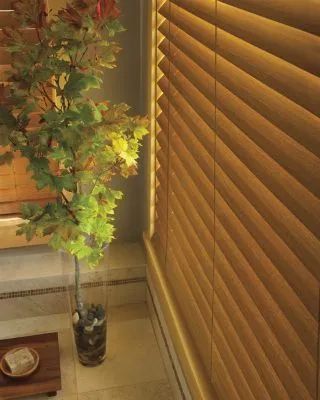 Love is Blinds, MO: A close-up of real wood blinds in natural brown. 