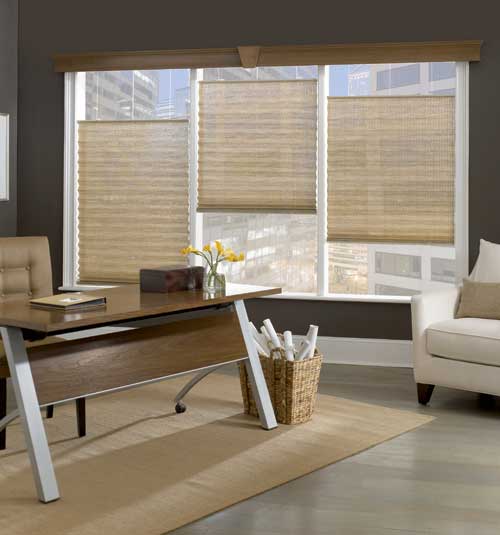 a living room with a desk , chair , and window with pleated shades Love is Blinds Missouri (314) 808-3440.