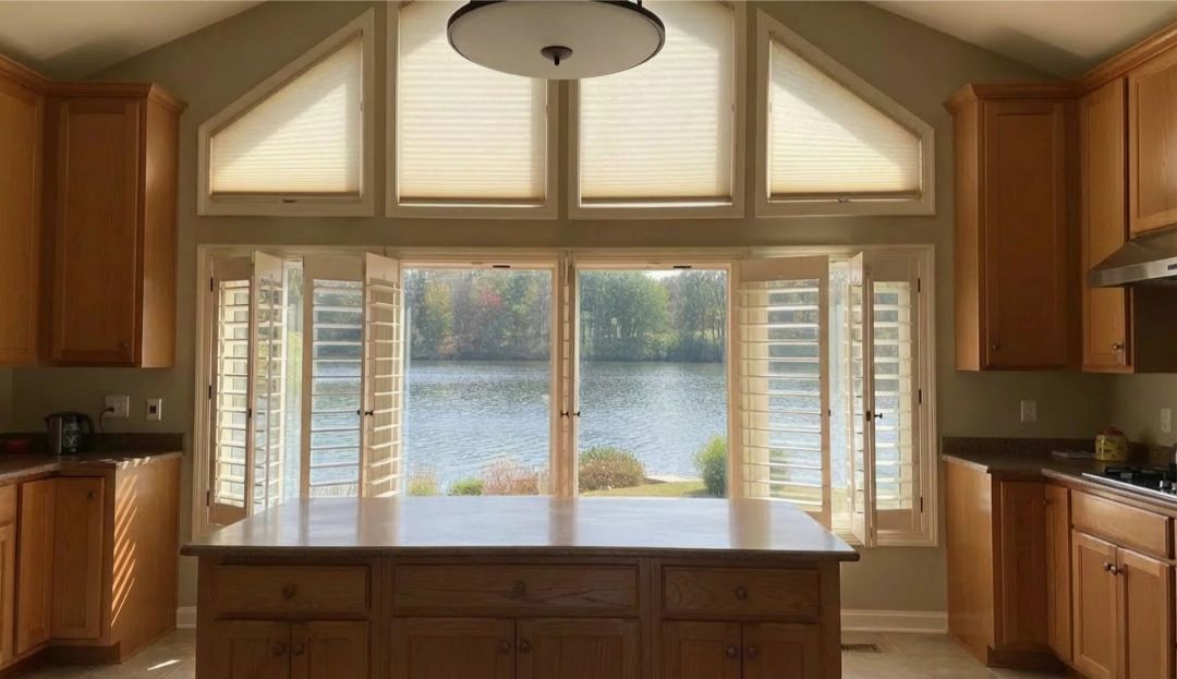 Triangle windows with fitted custom treatments in a Missouri kitchen, showing effective options by Love is Blinds.