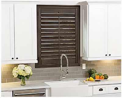 Love is Blinds St. Louis: A kitchen with white cabinets , a sink , and a window with shutters.