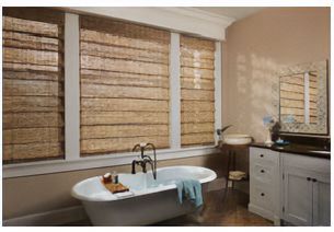 Love is Blinds MO: A bathroom with a bathtub and bamboo blinds on the windows.