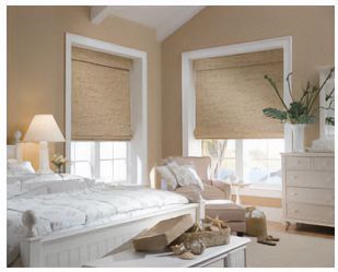 Love is Blinds St. Louis: A bedroom with a bed , chair, dresser, and woven wood blinds on the windows. 