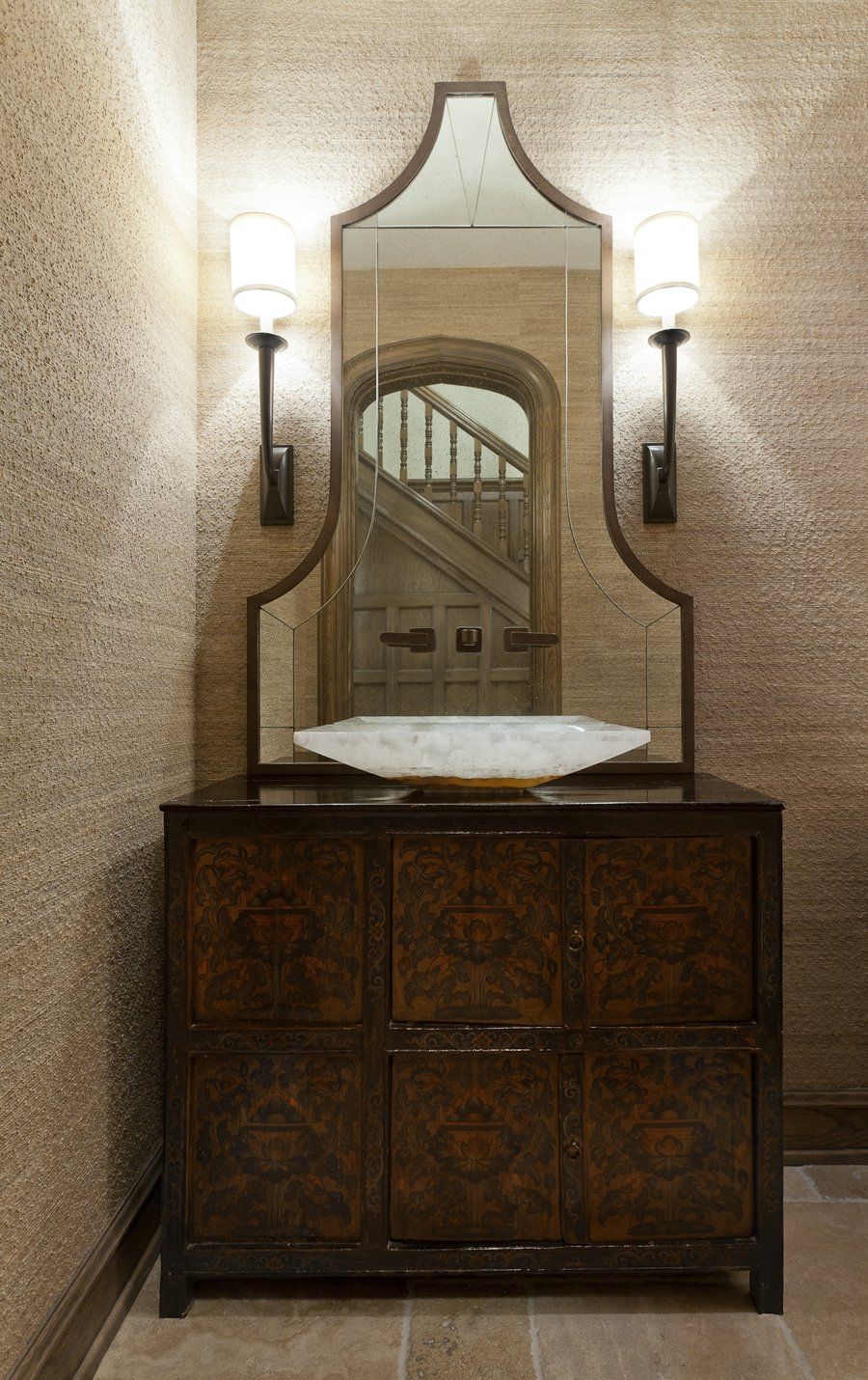 A bathroom with a sink and a mirror on the wall.