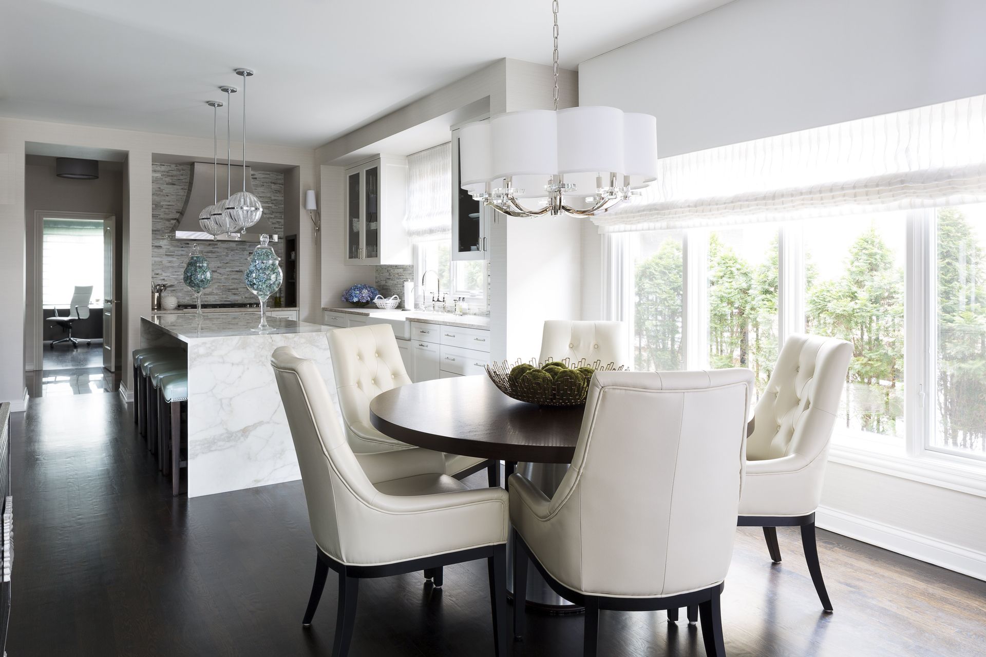 A dining room with a table and chairs and a chandelier.