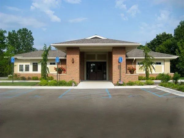 Building with brick columns, accessible parking, and accessible entrance.