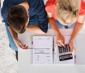 Financial Planning — Top View Of Couple Calculating in Schererville, IN