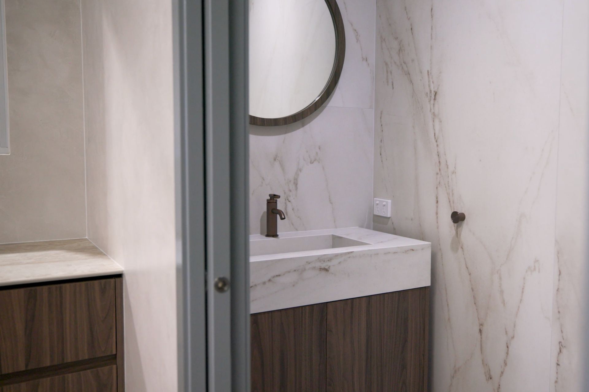Bathroom vanity with stone surface and wall application in Cairns showroom