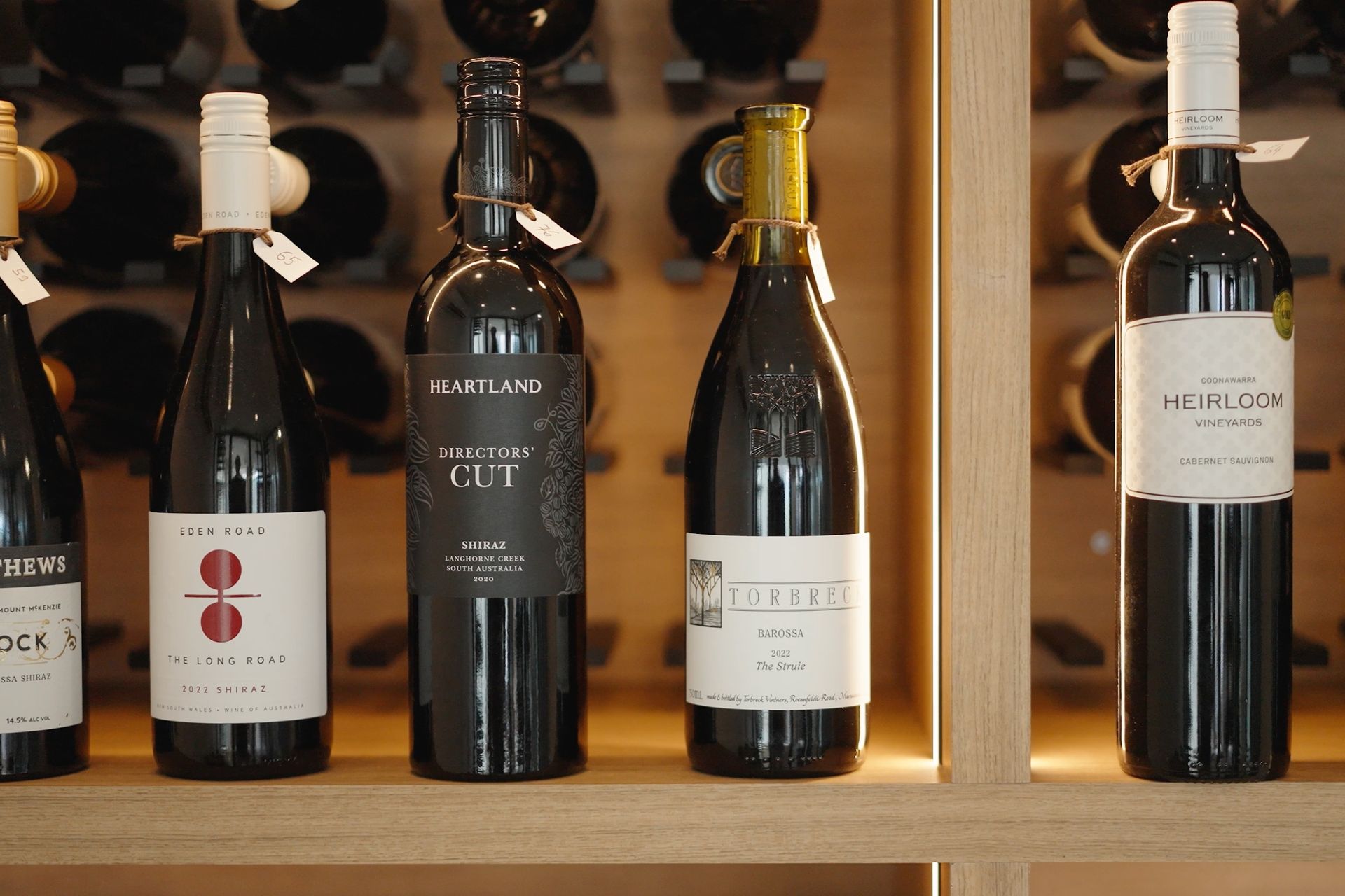 Wine display highlighting bottles and custom cabinetry and shelving