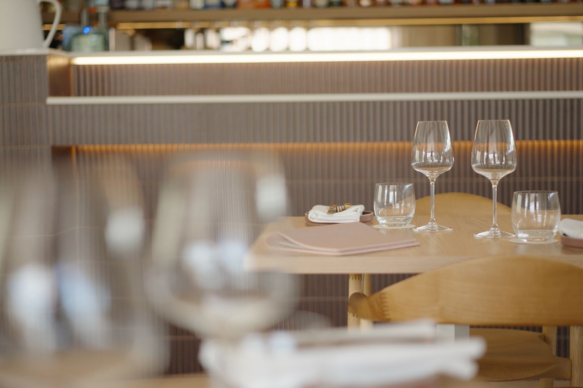 View of tiled front bar showing feature downlights and timber chairs