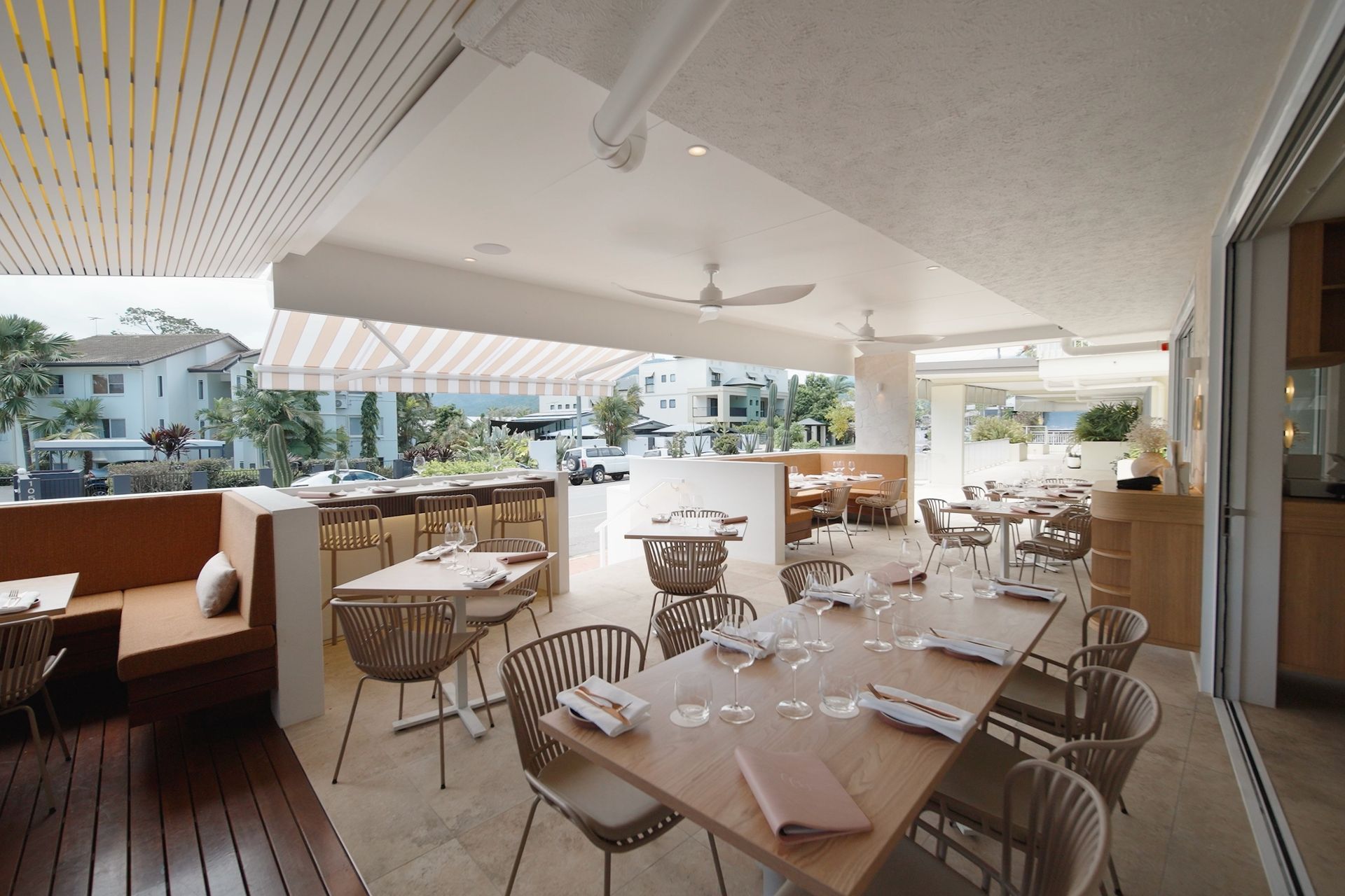 Wide view of GiGi dining terrace with curved bar and ceiling detail