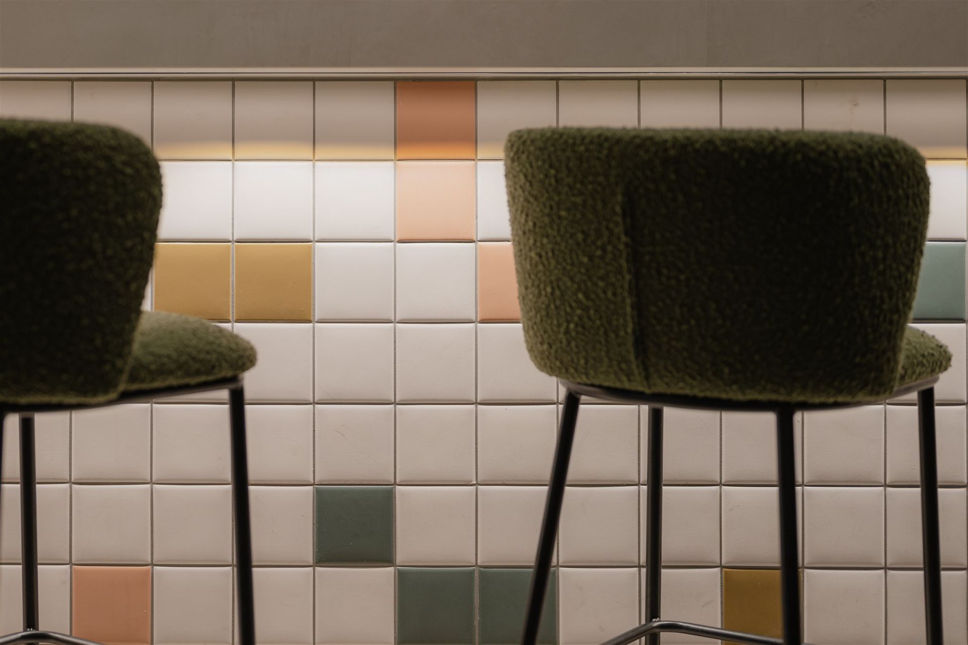 Detail view of the bar highlighting tile palette, joinery and ambient lighting
