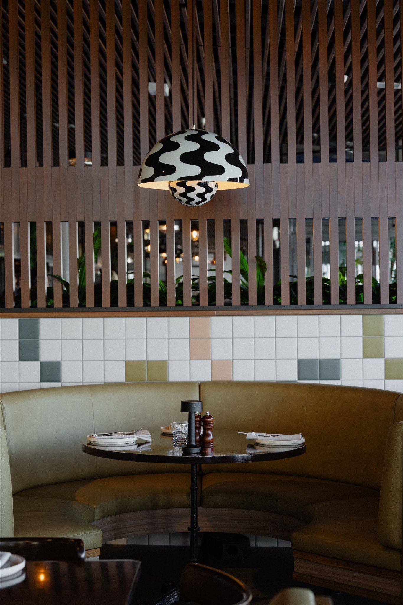 Curved booth seating at Ollie’s Italian showing joinery, upholstery and material detailing