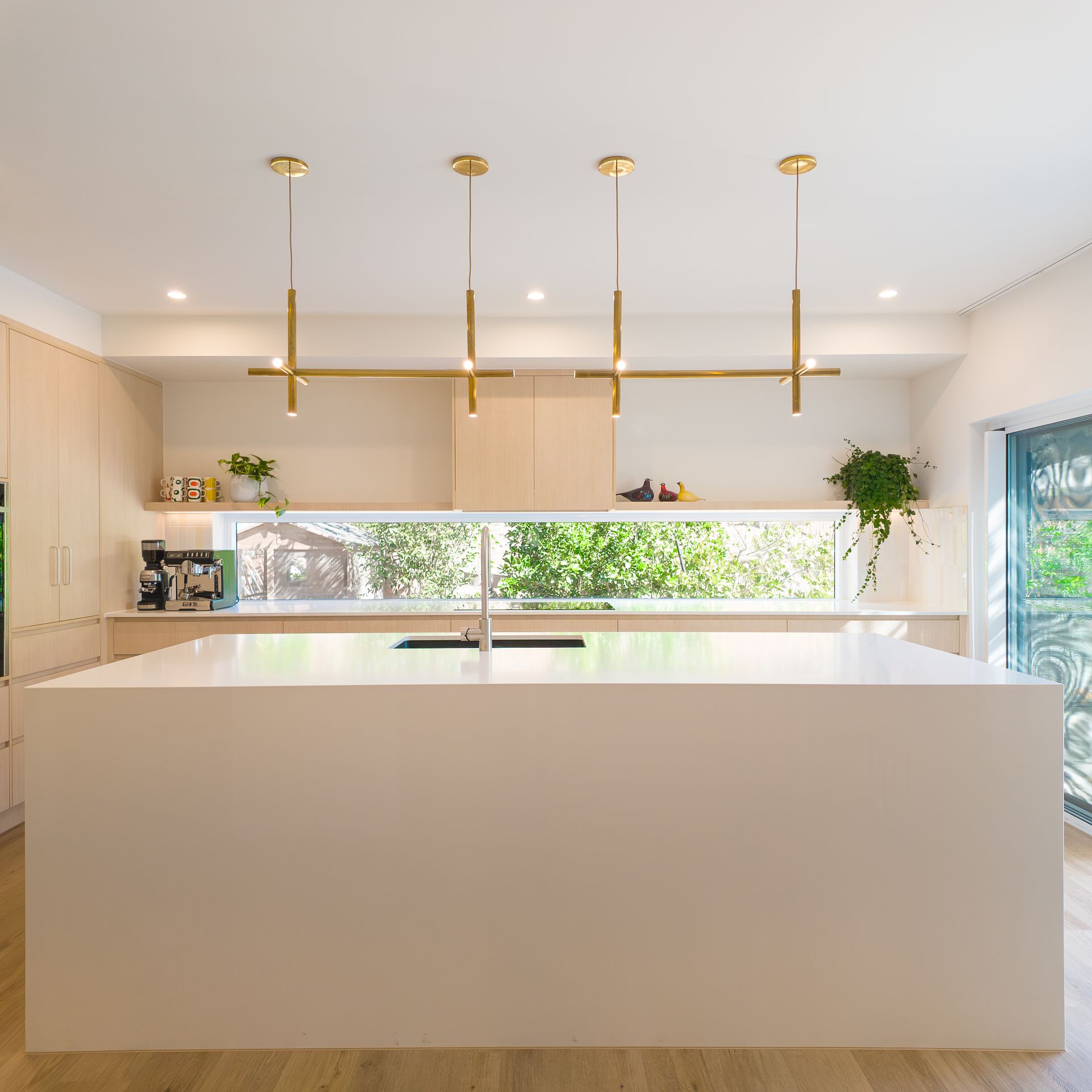 Kitchen with large island, pendant lighting and indoor outdoor connection
