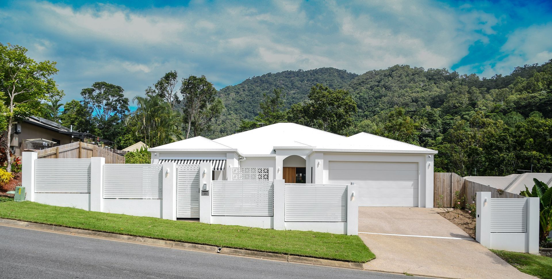 West Parkridge Cairns home exterior with clean white facade and landscaping