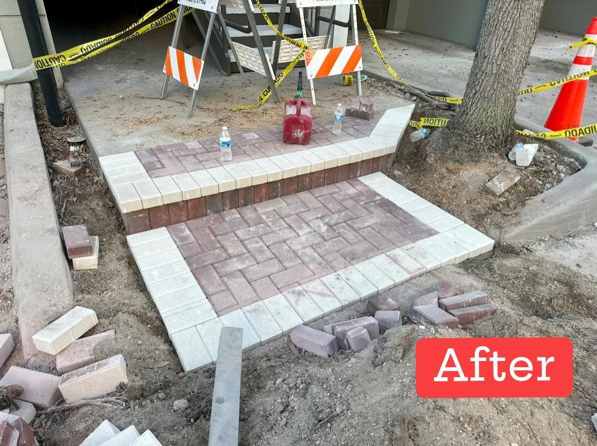 Newly constructed brick steps in a commercial setting, framed in light stone, with safety barriers around.