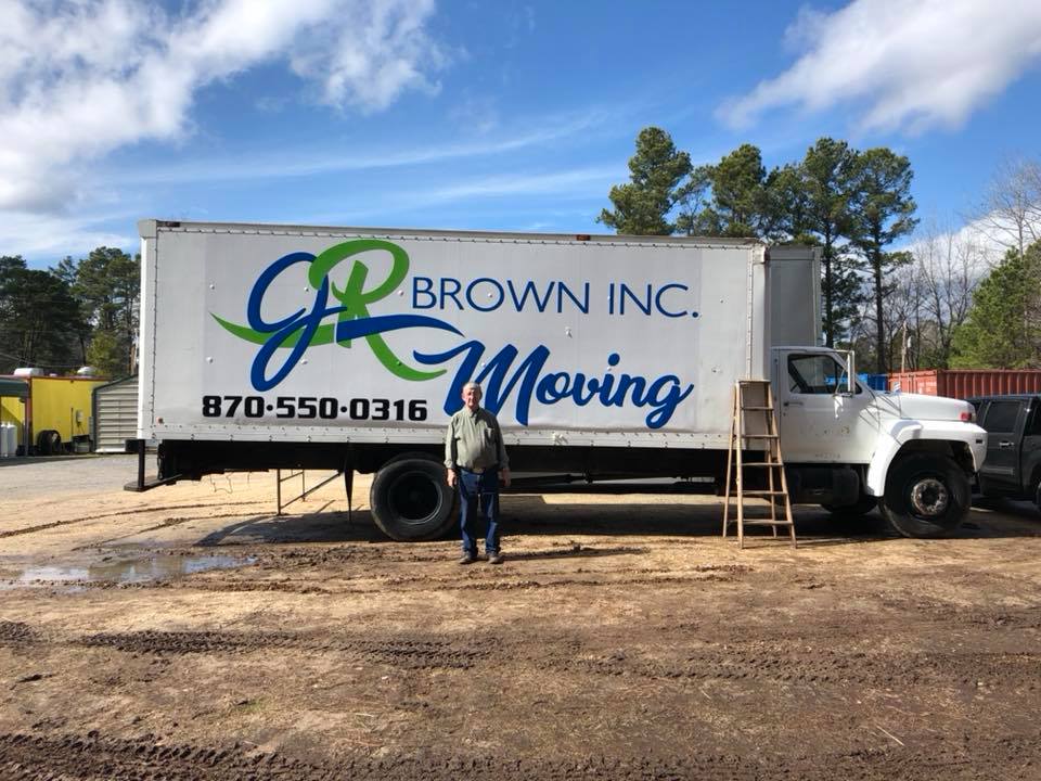 jr brown posing in front of one of his trucks