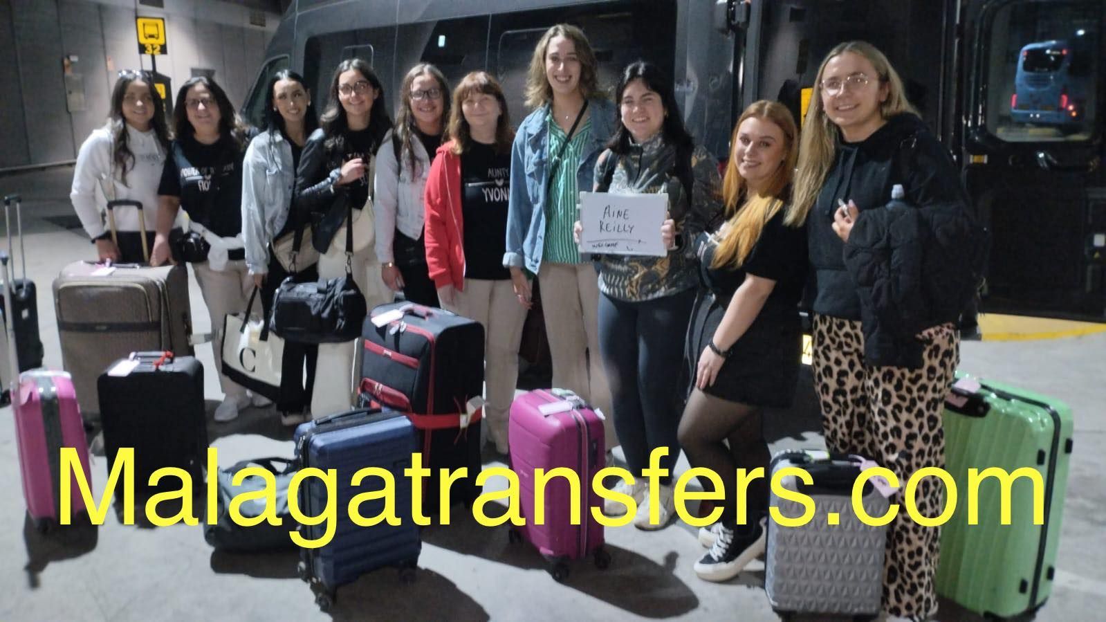 A group of women standing next to suitcases with the website malagatransfers.com in the corner