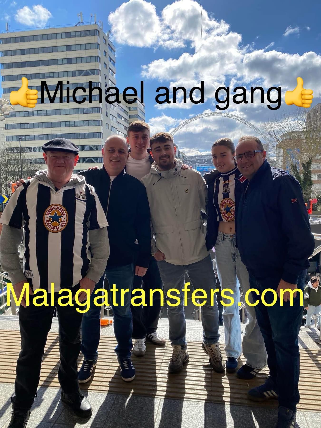 A group of men are standing next to each other in front of a building.