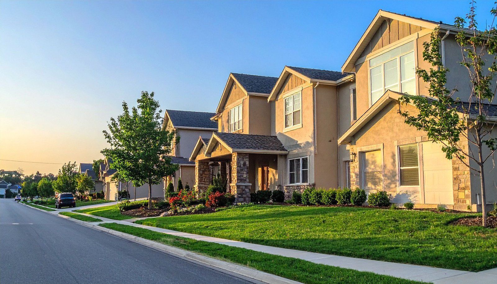 A homeowners insurance form with a pen and a wooden house.