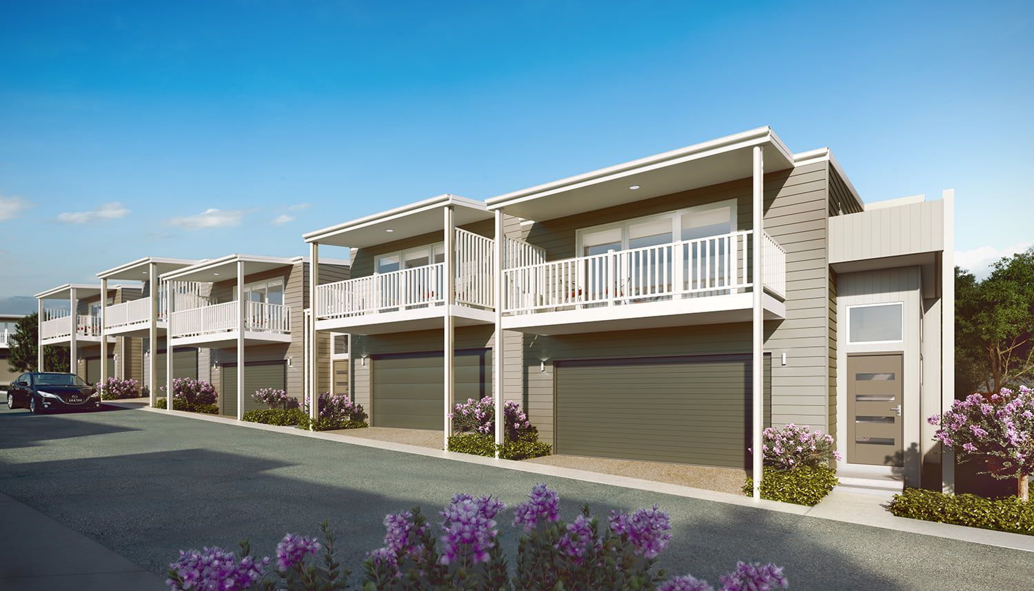 A Row Of Houses With Purple Flowers In Front Of Them — Harrison Development Group In Surfers Paradise, QLD