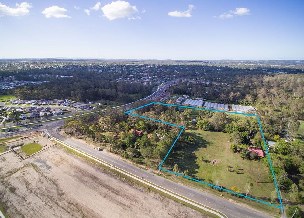 An Aerial View Of A Residential Area With A Road And Trees β Harrison Development Group In Surfers Paradise, QLD