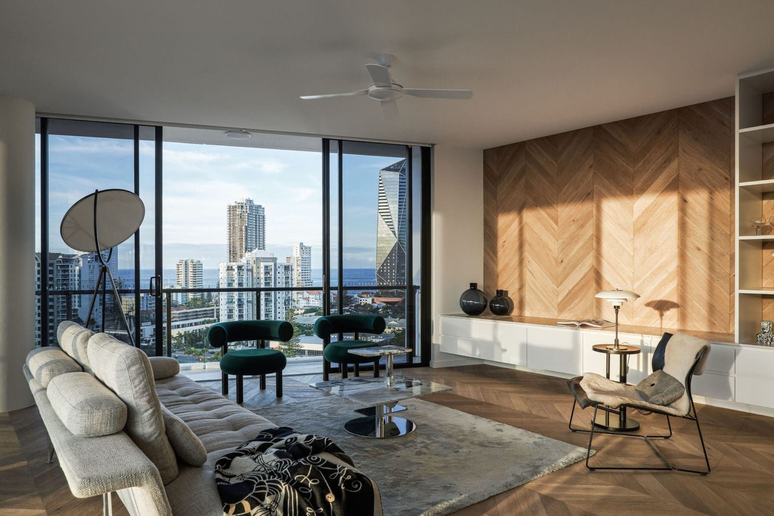 A Living Room With A Couch, Chairs, And A Ceiling Fan — Harrison Development Group In Surfers Paradise, QLD