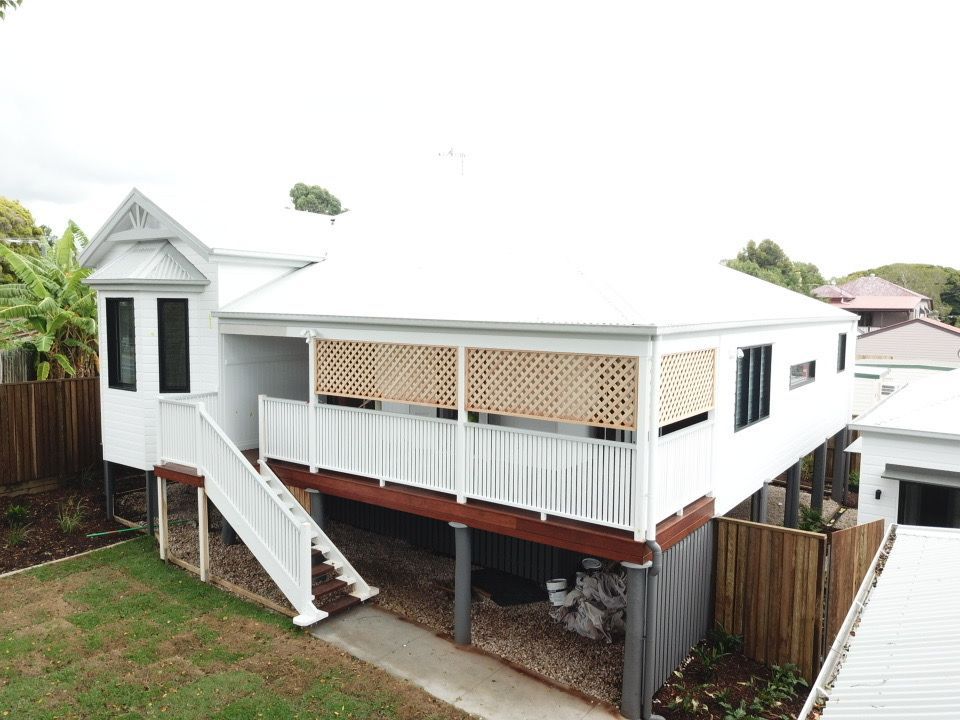 An Aerial View Of A White House With A Balcony And Stairs — Harrison Development Group In Surfers Paradise, QLD