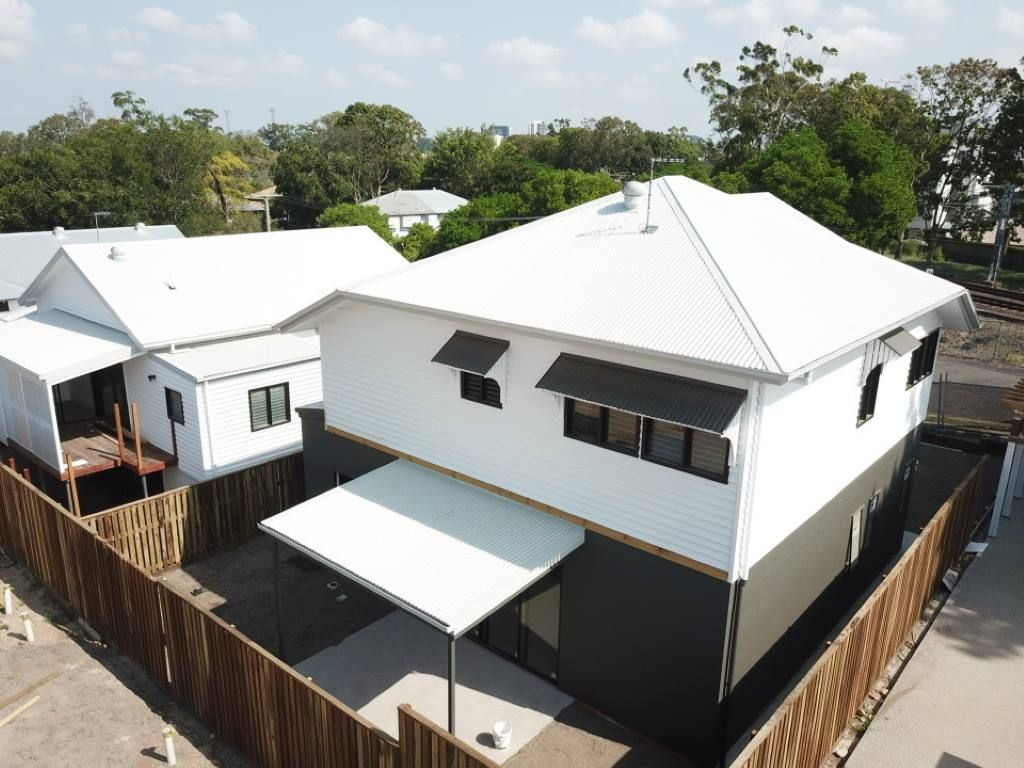 An Aerial View Of A White House With A Wooden Fence Around It — Harrison Development Group In Surfers Paradise, QLD
