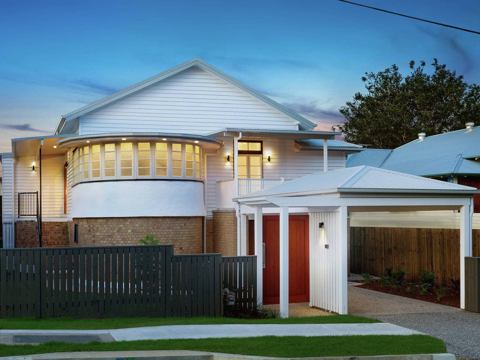 A White House With A Red Door And A Black Fence β Harrison Development Group In Surfers Paradise, QLD