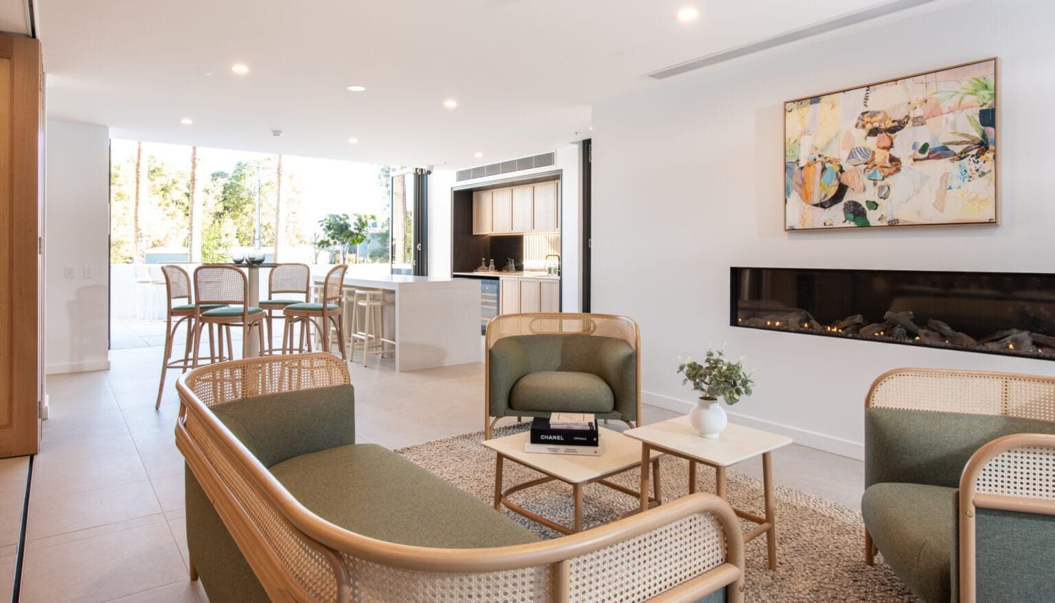 A Living Room With A Couch, Chairs, Tables And A Fireplace — Harrison Development Group In Surfers Paradise, QLD